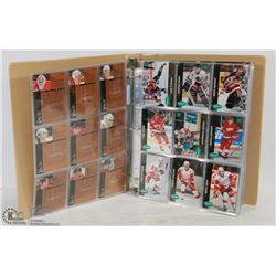 BINDER OF ASSORTED HOCKEY CARDS.