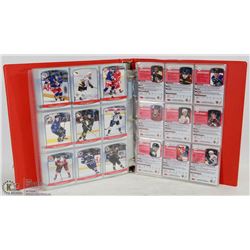 BINDER OF ASSORTED HOCKEY CARDS.