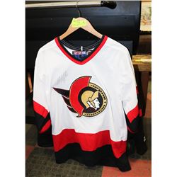 SIGNED #25 CHRIS NEIL ON A CHRIS PHILLIPS JERSEY.