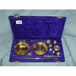 Cased set of brass postal weights