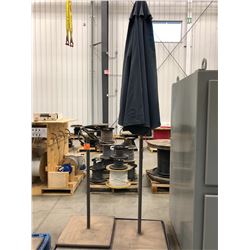 Qty 1 umbrellas with 2 solid steel stand, material sun faded, stand faded spots of rust