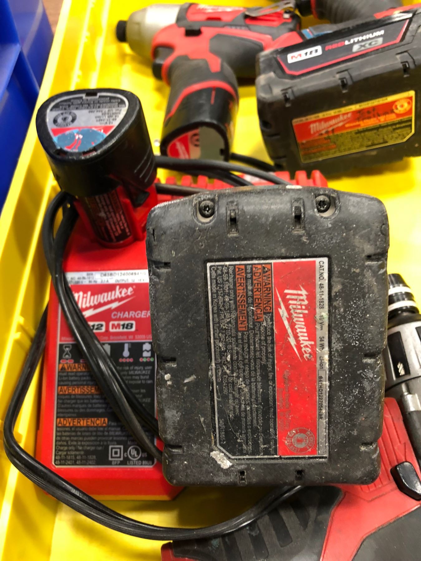 Milwaukee M18 drill, M18 impact, M12 driver, M12 impact M12 flashlight, 2 extra M12 battery & chargi