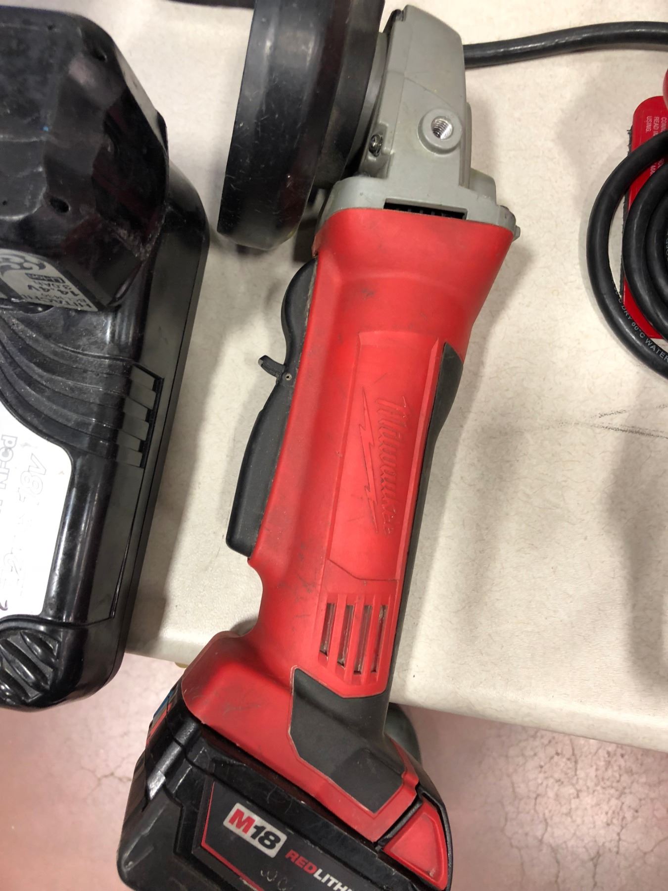 Milwaukee M18 drill, M18 angle grinder, qty 3 M12 drivers, M12 impact, M12 flashlight, M12 battery,
