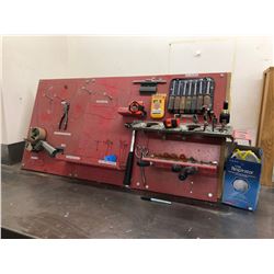 Tool board includes screwdrivers, nut drivers tape measures, hammer, tape gun, particle masks