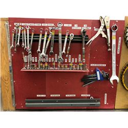 Tool board with storage includes sockets, wrenches, Allen keys, saw blades, face shield, dustpan
