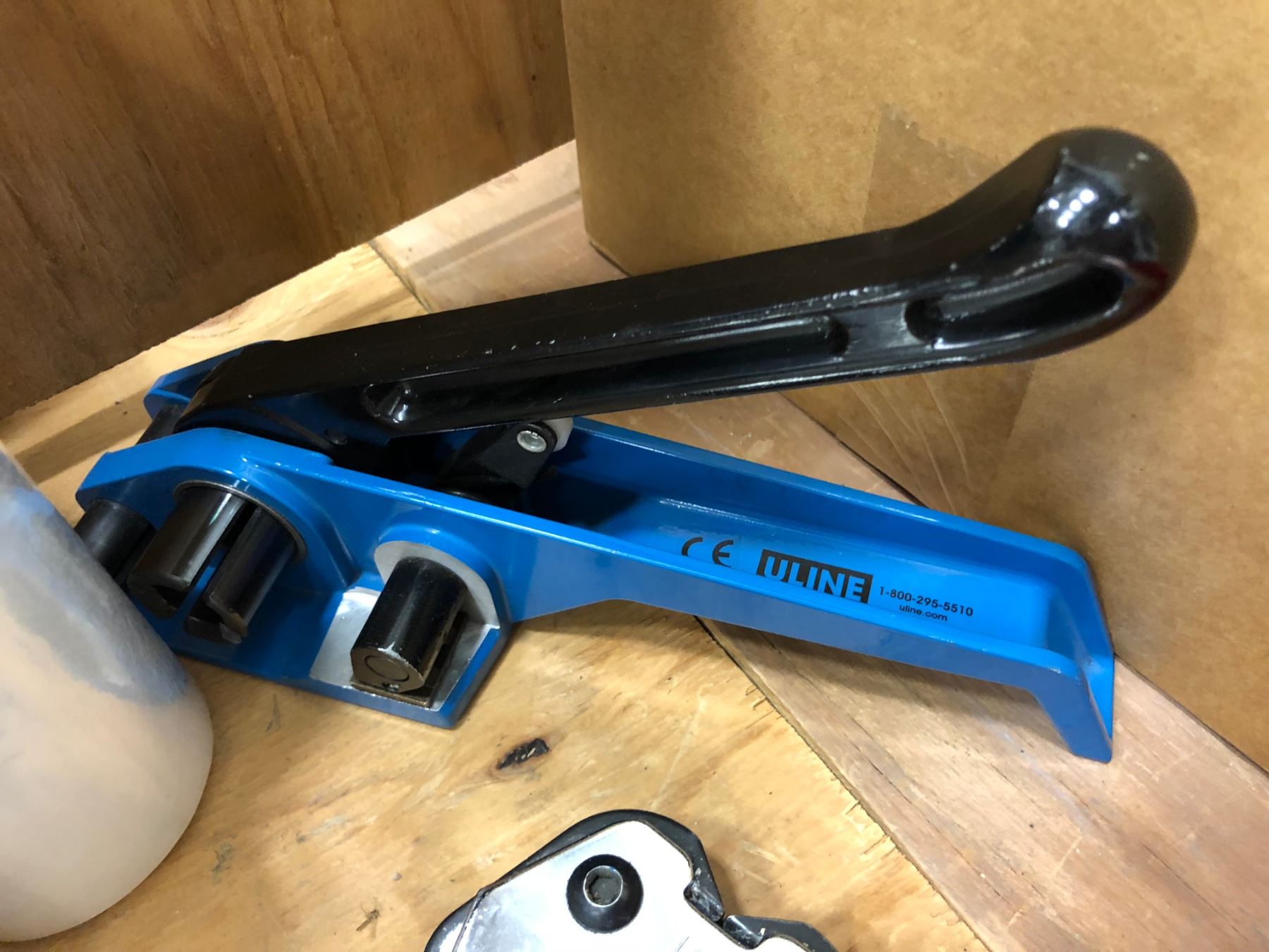 Shipping supplies, roll of poly, Uline bander & crimper, boxes of