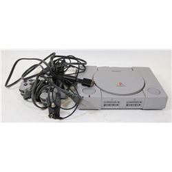 PLAYSTATION 1 WITH TWO CONTROLLERS/AV CORDS