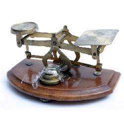 Set of brass postal scales on woodstand with weights