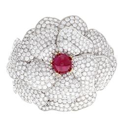 BRACELET: (1) 18KWG bracelet, ‘’Kwiat’’ floral design cuff, 11.0mm cab ruby 7.00 cts. TWA, 375 rbc d