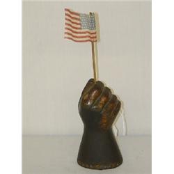 LATE 19TH CENT. CAST IRON FIST W/ FLAG PAPERWEIGHT