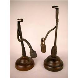 A GROUP OF TWO WEIGHTED RUSH LIGHTS ON WOOD STANDS, CONTINENTAL