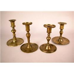A GROUP OF FOUR ROUND BASE BRASS CANDLESTICKS,CONTINENTAL