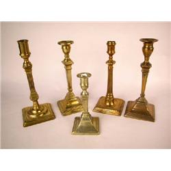 A GROUP OF FIVE BRASS AND BELL METAL CANDLESTICKS, ENGLISH