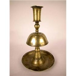 A BRASS ROUND BASE CANDLESTICK, PERSIAN