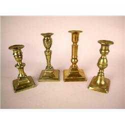 A GROUP OF FOUR BRASS MID SIZE CANDLESTICKS, ENGLISH