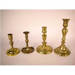 A GROUP OF FOUR BRASS CANDLESTICKS, CONTINENTAL
