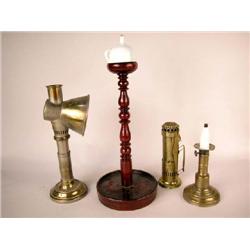 A GROUP OF FOUR LIGHTING DEVICES