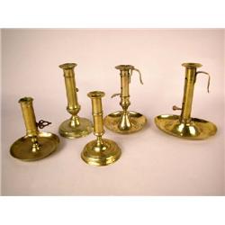 A GROUP OF FIVE BRASS PUSH EJECT CHAMBERSTICKS, ENGLISH Tallest 7 1/2"h
