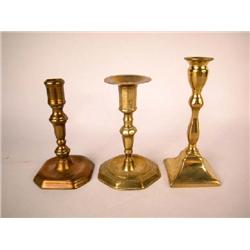 A GROUP OF THREE BRASS AND BELL METAL CANDLESTICKS, ENGLISH