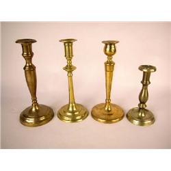 A GROUP OF FOUR ROUND BASE CANDLESTICKS, CONTINENTAL