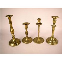 A GROUP OF FOUR BRASS CANDLESTICKS, CONTINENTAL