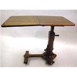 A VICTORIAN FIGURED WALNUT ADJUSTABLE READING TABLE