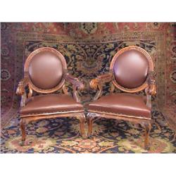 A PAIR OF VICTORIAN CARVED OAK ARMCHAIRS