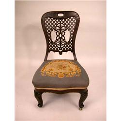 A VICTORIAN CARVED WALNUT SLIPPER CHAIR