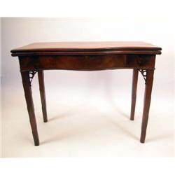 A GEORGE III FIGURED MAHOGANY SERPENTINE FRONT GAMES TABLE