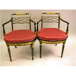 A PAIR OF REGENCY PARCEL-GILT EBONIZED CANE SEAT OPEN ARMCHAIRS