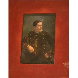 AN EGLOMISE PORTRAIT OF A SOLDIER IN UNIFORM GAZING LEFT