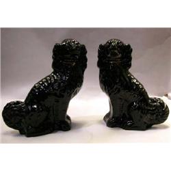 A PAIR OF STAFFORDSHIRE EBONIZED SPANIELS