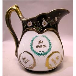 A BROWN AND FLORAL DECORATED WATER PITCHER