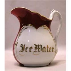 A RED AND GILT DECORATED WATER PITCHER