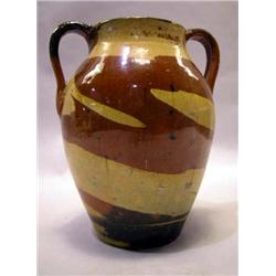A YELLOW AND BROWN GLAZED DOUBLE HANDELED REDWARE POTTERY VASE