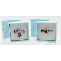 TWO RUBY COLORED STERLING SILVER RINGS