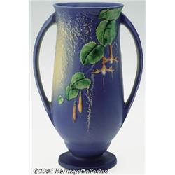 Roseville: A FUCHSIA BLUE AMERICAN POTTERY FOOTED VASE (Roseville)