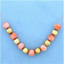 Pink Coral and Gold Ball Necklace in 14K Yellow Gold.