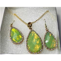 15)  GOLD TONE SETTING WITH PALE GREEN