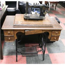 ANTIQUE SINGER TREADLE SEWING MACHINE IN CABINET.