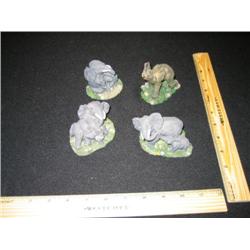 These four hand carved elephants are a set and depict family life in the village.