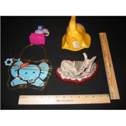 Four elephants, one is a child sip cup using the trunk as a straw. We have a hand carved family of e
