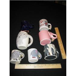 Seven elephants coffee mugs, various colors and sizes.