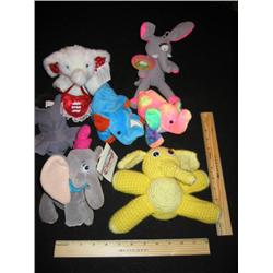 Seven soft and cuddaly little elephants, some are bean bags some are stuffed.