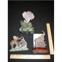 Three elephants, the rear elephant is a one of kind crystal bust on a rock pedestal. Very expensive 