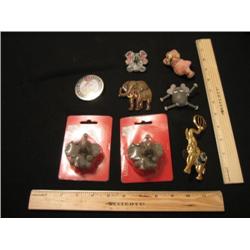 Nine whimsical elephant refrigerator magnets.