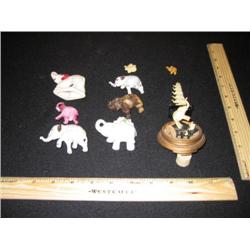 This herd of 10 elephants includes one set of two white elephants adorned in gold.As well as some po