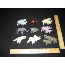 9 elephants of various types, some porcelain, some ceramic, petite and colorful.