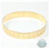 Image 1 : Lady's 10K Yellow Gold Etched Bangle Bracelet. Measures approx. 2 3/4 inches in diameter and weighs 