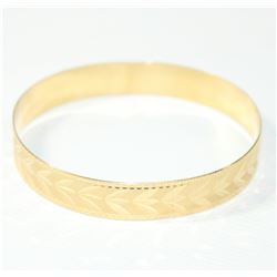Lady's 10K Yellow Gold Etched Bangle Bracelet. Measures approx. 2 3/4 inches in diameter and weighs 